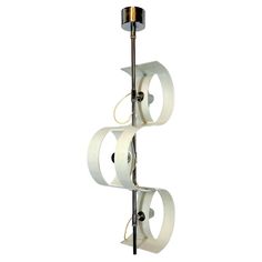 three rolls of toilet paper are hanging from a metal pole on a white background,