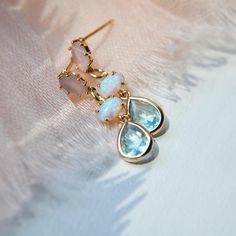 These something blue dainty earrings are created with tiny synthetic iridescent opal bezels secured to tiny faceted light green blue glass teardrops. The earring posts are created with gold plated over sterling silver and set with light pink glass. Whether searching for boho earrings as a birthday gift for a best friend or something special just for you, all of my jewelry arrives suitably gift wrapped ready for gift giving. Measurements: The dainty opal earrings hang approx. 1" long Metals: 14k Blue Drop Earrings As Gift For Her, Dainty Blue Gemstone Earrings, Light Blue Dangle Earrings For Pierced Ears, Blue Dangle Earrings As A Gift For Her, Dainty Crystal Drop Earrings For Pierced Ears, Dainty Drop Crystal Earrings For Pierced Ears, Delicate Gemstone Drop Earrings, Dainty Teardrop Earrings For Her, Dainty Teardrop Earrings As Gift For Her