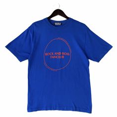 a blue t - shirt with the words rock and roll fanclr printed on it