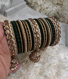 Green Pearl Kundan Stone Jhumki Bangle Set, complemented by vibrant metal bangles, is a perfect choice for adding a touch of elegance to your Indian attire, especially during weddings and festivals. Don't miss the exquisite Green Kundan Bridal Bangle Set, featuring three beautiful Jhumki kadas that promise to make you the center of attention on your special day. Embrace tradition with these enchanting designs Size: 2.4in (Small) ,2.6in (Medium), 2.8in (Large) , 2.10in (Extra Large) Disclaimer: P Kundan Kada Design, Wedding Bangles Indian, Pakistani Jewelry Bridal, Bridal Bangle Set, Bridal Jewlery, Wedding Jewellery Designs, Wedding Bangles, Kundan Bangles, Wedding Lehenga Designs