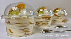 three desserts in plastic containers with spoons on the side