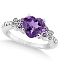 Long reserved solely for royalty, the amethyst is a majestic gemstone your queen is sure to love, especially in this butterfly designed amethyst and diamond heart engagement ring. Featuring an approximate carat weight of 2.48 total carats, this stunning ring features a total of 5 genuine amethysts and 10 diamonds. Set in 14k white gold this dazzling engagement ring is sure to please. #engagementring #engagementringideas #engagementringselfie  #engagementringonline#engagementringdesigner Purple Engagement Rings, Butterfly Engagement Ring, Heart Engagement Ring, Shell Jewellery, Heart Engagement, Diamond Sapphire Engagement Ring, Sapphire Diamond Engagement, Amethyst Ring Engagement, Jewelry Swarovski