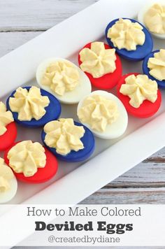 red, white and blue cupcakes with cream frosting in a tray on a wooden table