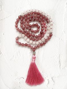 This mala necklace is made with 108 natural stone beads of pink lepidolite and white agate adorned with silver beads. This prayer garland  is the perfect support garland for counting mantras during your practices. Its a 108 knotted beads mala, very light weight, a spiritual sacred jewelry for chakra healing. I make each mala by hand, knotting each of the 108 beads with great care and I made every single silky and delicate tassel. I use a very resistant braided macrame rope, achieving a mala that White Hand-strung Crystal Necklace For Gift, White Adjustable Mala With Gemstone Beads, Adjustable White Mala With Gemstone Beads, Adjustable White Gemstone Beads Mala, Rose Quartz Necklace With Gemstone Beads For Meditation, Spiritual Pink Crystal Necklaces For Healing, Pink Spiritual Crystal Necklace For Meditation, Spiritual Pink Beaded Necklaces With Natural Stones, White Beaded Necklaces With Natural Stones For Meditation