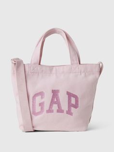 Soft cotton tote bag.  Straps at top.  Adjustable shoulder strap.  Gap arch logo in glitter or sequins at front.  Inner pocket.  Dimensions: 8"H x 4" W x 11" D Everyday Pink Bags, Pink Cotton Bag With Adjustable Strap, Casual Gap Bags For Everyday Use, Pink Cotton Canvas Bag With Adjustable Strap, Sparkle Logo, Tote Bag Straps, Logo Tote Bag, Arch Logo, Gender Equality