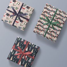 three presents wrapped in wrapping paper with bows