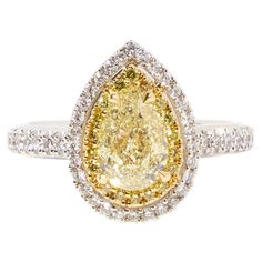 18 karat white gold ring set with a 1.51ct-fancy yellow pear-cut diamond This ring with a 1.51 ct pear-cut fancy yellow diamond, surrounded by an entourage of white diamonds, is a unique creation from our workshop. Crafted in 18-carat white gold, the ring features a band encrusted with diamonds. The central 1.51 ct fancy yellow pear-cut diamond, complemented by 0.44 ct of top Wesselton VVS white diamonds, gives the ring a classic bicolor effect. This ring stands out when paired with our one-of-a Canary Yellow Diamond Engagement Ring, Canary Yellow Diamonds, Yellow Diamond Engagement Ring, Fancy Yellow Diamond, Pear Cut Diamond, Gold Ring Sets, Canary Yellow, White Gold Ring, Colorful Bracelets