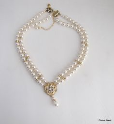 "This romantic double strand necklace has a victorian style rose pendant with clear stones set on an antique gold filigree. I have used Swarovski pearls in ivory/cream. All the Swarovski crystals in the pendant are handset by me. Pearls measure 8 mm in both strands accented with rhinestone beads. Rhinestone pendant is just under 1\" in diameter. Necklace is 17\" long inner strand. Finished off with antique gold finish filigree clasp adorned with Swarovski crystals. It comes with a 2\" extender c Double Strand Pearl Drop Jewelry For Wedding, Double Strand Gold Wedding Jewelry, Gold Double Strand Wedding Jewelry, Double Strand Gold Jewelry For Wedding, Victorian Pearl Necklace For Wedding, Delicate Double Strand Necklace For Wedding, Gold Double Strand Necklace For Wedding, Gold Pearl Embellished Necklaces For Wedding, Gold Pearl Chain Necklace For Mother Of The Bride