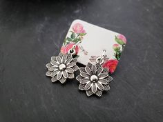 These earrings feature detailed Tibetan silver flower charms on French hook earwires. The overall length is 1 1/4 inches. Earwires Finish  ~ Silver Plated  ~ Sterling Silver