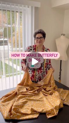 a woman sitting on top of a table with a yellow blanket over her face and the words how to make butterfly dits