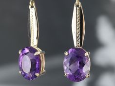 Here we've set deep, rich, purple amethyst in simple baskets of yellow gold. The open back allows light through the entire stone, accentuating the superb cutting of these rich, bright stones! The bar in the centers are sleek and polished originally links from a vintage watch chain. At the very top are the earring wires, hinged lever backs which are brand new, yellow gold with a simple polished design. These are comfortable to wear and very secure! Metal: 14K Yellow Gold Gem: 2 Amethyst totaling Bridal Earrings Drop, Earring Wires, Rich Purple, Cameo Ring, Oval Earring, Watch Chain, February Birthstone, Yellow Gold Earring, Amethyst Earrings