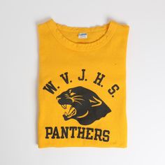 This vintage 1970s era Champion Lastone print collegiate Football Style t-shirt features excellent graphics in a bold yellow-and-black coloration. This great example comes from West Valley Junior High School and includes their school's illustrative panther mascot. Sizing Fits about a medium with potential to stretch out further if desired. Provided below are measurements to aid in sizing, please use them as a reference and do not rely solely on the tag. Measurements 37" chest / 18.5" pit to pit Retro T-shirt With Letter Print For College, Retro College T-shirt With Screen Print, Retro College T-shirt With Text Print, Retro Letter Print T-shirt For College, Retro College T-shirt With Letter Print, Collegiate Yellow Crew Neck Top, Collegiate Yellow Tops With Letter Print, Retro Screen Print T-shirt For College, Yellow School Spirit Graphic Print Top