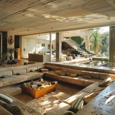 a living room filled with furniture and lots of windows