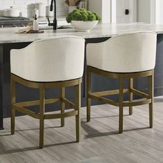 two white chairs sitting on top of a kitchen counter