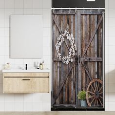 a bathroom with a wooden door that has a wreath on it and an old wheel