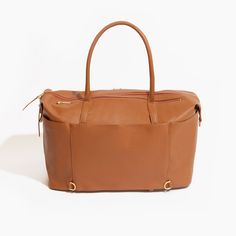 a tan leather handbag on a white background