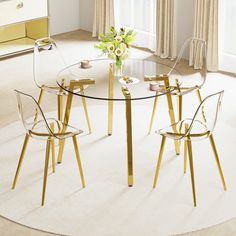 a glass table with four chairs and a vase on top of it in front of a window