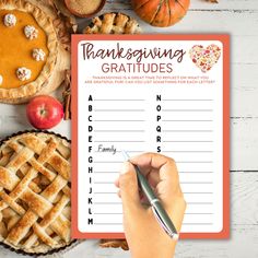 a hand writing on a thanksgiving greeting card with pies, apples and other food