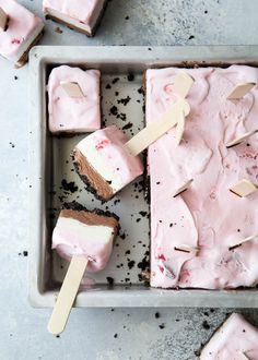 ice cream and marshmallows in a pan with popsicles on the side