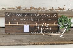 a wooden sign that says our favorite people call us mom and papa with clothes pins attached to it