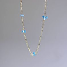 Swiss blue, faceted, blue topaz cones adorn this delicate gold necklace. This is one of my favorite new designs. I made it in a assymetrical way with stones in graduated sizes scattered around the 18k solid chain. I love how shimmery the gems are, they look like little stars shining all around the neckline. Beautiful, subtle, precious and chic this choker necklace is perfect on its own or layered with other necklaces. 15 inches long, closes with a spring clasp. Topaz from 4x6.5mm to 2x 3.5mm Tha Blue Topaz Fine Jewelry Necklace, Fine Blue Topaz Necklace In Blue, Blue Topaz Briolette Necklace In Fine Jewelry Style, Fine Jewelry Blue Topaz Briolette Necklace, Gold Faceted Blue Topaz Necklaces, Gold Necklace With Blue Topaz Briolette, Gold Necklace With Faceted Blue Topaz, Gold Briolette Blue Topaz Necklace, Blue Topaz Briolette Necklaces