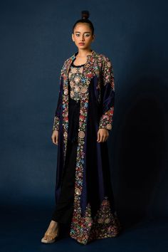 Blue silk long jacket, highlighted with floral and zardozi hand embroidery. Paired with an inner top with all over floral hand embroidery and fringed tassels.
Components: 2
Pattern: Hand Embroidery
Type Of Work: Floral, Zardozi
Neckline: Top: Round Neck
Sleeve Type: Jacket: Full Sleeves
Fabric: Silk
Color: Blue
Other Details: 
Note: Pant worn by the model is not for sale
Occasion: Sangeet,Party - Aza Fashions Floral Embroidered Chanderi Nehru Jacket With Long Sleeves, Silk Outerwear With Zari Work And Long Sleeves, Long Sleeve Chanderi Nehru Jacket With Floral Embroidery, Anarkali Style Embroidered Nehru Jacket For Reception, Blue Floral Embroidered Bandhgala For Designer Wear, Transitional Silk Bandhgala With Floral Embroidery, Silk Bandhgala With Floral Embroidery For Festive Occasions, Festive Silk Bandhgala With Floral Embroidery, Designer Chanderi Outerwear With Resham Embroidery