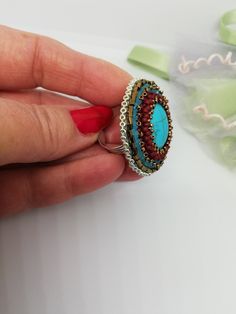 Beautiful ethnic style ring, hand embroidered with glass pearls and crystals and a central turquoise stone. It is difficult and slow work. Each bead is individually hand sewn with the aim of creating the final design. Inside the ring is lined with soft synthetic leather which gives a soft touch to the skin. This ring is comfortable to wear, is adjustable and fits any finger size. You can wear it on different occasions, very nice to wear in summer. The ring is made with a 3cm circular silver metal base on which the workmanship is made. Wearing this ring will make you feel unique and special. If you would like a custom ring in the colors of your choice, contact me and I will be more than happy to create a special ring just for you. All jewels are delivered in a decorated box, ready to be giv Artisan Handmade Turquoise Ring For Wedding, Artisan Handmade Turquoise Wedding Ring, Bohemian Crystal Ring With Stones, Bohemian Turquoise Ring With Stone Setting, Handmade Blue Bohemian Crystal Ring, Handmade Turquoise Wedding Ring, Handmade Artisan Crystal Ring, Artisan Handmade Crystal Ring, Turquoise Beaded Rings As A Gift