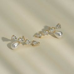 These stunning simulated diamond earrings offer a dazzling pear drop design, accented with either a luxurious pearl or vibrant emerald stone. Perfect for adding a touch of elegance to any outfit. 1'' Inch width Choose style below Earrings are final sale Jewelry Cleaning Solution, Hair Perfume, Drop Design, Emerald Stone, Drops Design, Small Jewelry, Cleaning Jewelry, Gold Plated Jewelry, Jewelry Plate