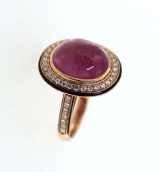 For Sale on 1stDibs - This striking ring features a captivating 7.55-carat cabochon pink tourmaline, set in a luxurious setting that showcases the gemstone's rich, saturated Luxury Ruby Ring With Oval Cabochon, Luxury Tourmaline Cabochon Rings, Elegant Pink Ruby Cabochon Ring, Elegant Pink Cabochon Ruby Ring, Fine Jewelry Pink Cabochon Ring, Elegant Pink Cabochon Rings, Pink Round Cabochon Ruby Ring, Pink Cabochon Ruby Ring, Classic Pink Cabochon Rings