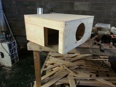 a wooden box sitting on top of a pile of wood