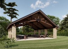 a picnic pavilion with tables and chairs in the grass near trees on a sunny day