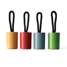 four different colored cups with black handles and roped ends on each one, all lined up in the same row