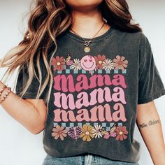 Retro Floral Mama T-shirt Gift for Mom Shirt for Mother's Day Mama T-shirt Botanical Shirt for Mom Smiley Mother's Day Shirt Gift for wife  *Please size up 1-3 sizes if you would like the oversized look! UNISEX SHIRTS SIZES: The models in the photo images are wearing 1 or 2 sizes up, so please order 1 or 2 sizes up for an oversized look. Many customers say that it's only a bit oversized look or true to size for women's size when you choose your normal women's size. PRINTS: We use high quality Direct-to-garment (DTG) printing! DTG printing method is used for printing on clothing, and the process itself resembles digital printing on paper. DTG printing produces professional high quality design.  SOFTNESS: When you receive it, the shirt looks a little stiff, but after washing over the time it Mother's Day Graphic Tee With Text Print, Family Matching Letter Print T-shirt For Spring, Mother's Day Short Sleeve Shirt With Custom Print, Cotton T-shirt With Letter Print For Mother's Day, Pink Graphic Print T-shirt For Mother's Day, Mother's Day Screen Print Crew Neck T-shirt, Trendy Tops With Funny Text For Mother's Day, Funny Graphic Print Tops As Gift, Mother's Day Shirt With Custom Print And Relaxed Fit