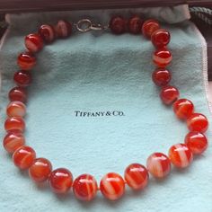 Tiffany & Co Carnelian Bead Necklace. Sterling Silver. 16mm Beads. 19.5 Inches End To End. In Amazing Condition. No Chips, Cracks Or Blemishes Of Any Kind To The Gemstones. The Cord Is Tight With No Fraying. Hallmarks As Pictured In The Inner Rim Of The Clasp. Comes With Large Tiffany Pouch. This Item Is Crosslisted Ebae- Hulutv Jewelry Tiffany, Carnelian Beads, Tiffany Co Jewelry, Necklace Sterling Silver, Bead Necklace, Tiffany & Co., Womens Jewelry Necklace, Beaded Necklace, Jewelry Necklaces