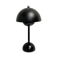 a black table lamp sitting on top of a white surface