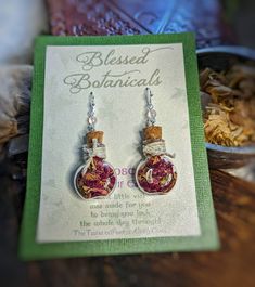 "Herbal magic is centuries old and can be found in cultures all over the world. Each little vial contains organically grown herbs and botanicals and comes packaged with a card describing the magic it brings! SAGE  - protection & happiness LAVENDER -  sweet dreams CHAMOMILE - peace & relaxation ROSE - Love & Self Esteem Earrings dangle roughly 1.5\" from sterling plated ear hooks" Healing Magic, Bottle Earrings, Herbal Healing, Herbal Magic, Witchy Jewelry, Growing Herbs, Earrings Dangle, Sweet Dreams, Self Esteem