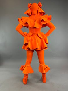 About this item Step into the spotlight with our vibrant Neon Orange Clown Exotic Dancewear – an elegant fusion of futuristic fashion, Coachella vibes, and trending club couture. This unisex bodysuit doubles as a Halloween showstopper and zentai fashion statement.Costume Details:Lycra Headpiece: A head-sock with big eye holes and fabric pointsils adorned with hand-made roses. Comfortable and easy to see through.Fabric: Lycra 4-way stretch and soft, glowing under fluorescent lights.Long Zipper on Creature Costume, Head Sock, Futuristic Clothing, Coachella Vibes, Catsuit Costume, Outrageous Fashion, Fluorescent Lights, Exotic Dance, Exotic Fashion