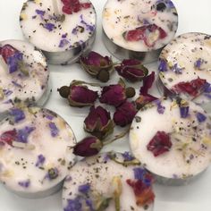 several different types of flowers on some tins