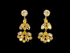 These exquisite clips earrings feature light yellow marquise rhinestones and slightly more vivid yellow rhinestone chatons, all prong set in gold tone metal. They are in excellent vintage condition and are unsigned though are of Weiss or Kramer quality! Absolutely beautiful, sparkly! They measure 1 3/4 by 7/8 inches. Feature Light, Clip Earrings, Rhinestone Earrings, Light Yellow, Gold Tone Metal, Prong Setting, Clip On Earrings, Etsy Earrings, Gold Tones