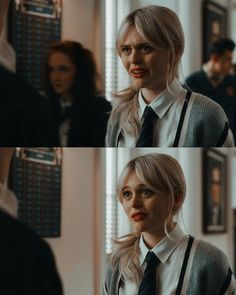 a woman with blonde hair wearing a white shirt and black tie in front of a mirror