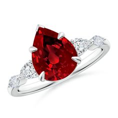 a ring with a red stone and white diamonds on the band, set in 18k white gold