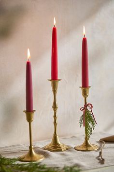 three red candles are sitting next to each other