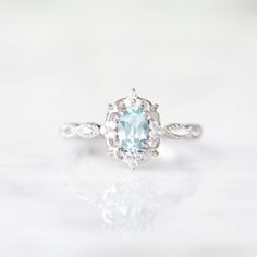 Beautiful vintage inspired aquamarine ring ►Made of solid sterling silver, rhodium plated (S925) ►Accented with simulated diamonds (CZ) Center Stone: Aquamarine Gemstone Cut: Oval Gem size: 6.0 x 4.0 mm Carat Weight: 0.43 ct. Stone Creation: Lab-Created Stone Origin: Brazil ►Handling time: 1-2 business days ►Free domestic shipping. Usually takes 2-5 business days. ►Wrapped & ready to give in a beautiful box. Classic Crystal Birthstone Ring For Anniversary, Classic Birthstone Crystal Ring For Anniversary, Vintage Halo Design Promise Ring, Classic Halo Ring With Birthstone, Vintage Birthstone Ring With Halo Setting For Promise, Anniversary Topaz Ring With Halo Design, Vintage Aquamarine Ring, Women March, Aquamarine Ring Vintage