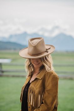 Western 50x in Sahara with custom distressing Teardrop crown Kettle curl on 3" brim Layered Elk leather accent bands Whipstitch on crown and brim Hand stitched Tonal Mountain detail Custom hand stitched initials upon request. This felt hat is made to order, please allow 6-8 weeks for delivery. Vintage Leather Hat Band For Fall, Rustic Leather Hat For Fall, Vintage Leather Hat Bands For Flat Crown, Classic Distressed Brown Hat With Curved Brim, Classic Hat With Curved Brim In Distressed Brown, Custom High Crown Leather Hat, Fitted Leather Ranch Hats, Leather Fedora With Flat Crown For Rodeo, Vintage Flat Crown Felt Hat For Ranch