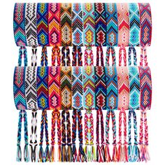 multicolored bracelets with tassels hanging from the side on a white background