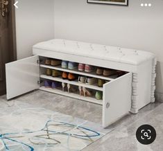 a white shoe bench with multiple pairs of shoes on it's bottom shelf next to a door