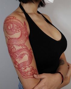 a woman with a dragon tattoo on her arm