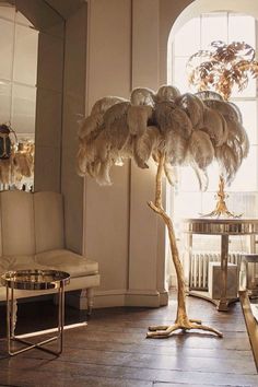 a living room filled with furniture and a tall tree in the middle of the room