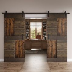 an empty room with wood paneling and sliding doors leading to a desk in the center