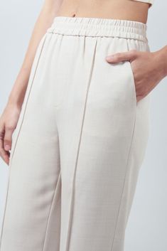 Introducing the Lakeyo Lorelei Pants, your new go-to for comfort and style. Made with 100% polyester, these pants are lightweight, breathable, and perfect for any occasion. The slim fit design flatters your figure, while the elastic waistband ensures a comfortable fit all day long. Whether you're dressing up for a night out or keeping it casual for a day at home, the Lorelei Pants will keep you looking and feeling your best. Upgrade your wardrobe with these versatile and fashionable pants today.- side pockets - front pleats details - side pockets - elastic waist design - tapered hemline Composition: 100% polyester Stretch Pants With Straight Hem For Summer, Summer Tapered Leg Sweatpants With Elastic Waistband, Stretch Business Casual Dress Pants With Elastic Waistband, Stretch Dress Pants With Elastic Waistband For Business Casual, Beige Stretch Tapered Leg Dress Pants, Relaxed Fit Ankle-length Pull-on Pants, 4-way Stretch Wide Leg Trousers With Elastic Waistband, Tapered Leg Stretch Bottoms With Elastic Side Panels, Stretch Tapered Leg Pants With Elastic Waistband